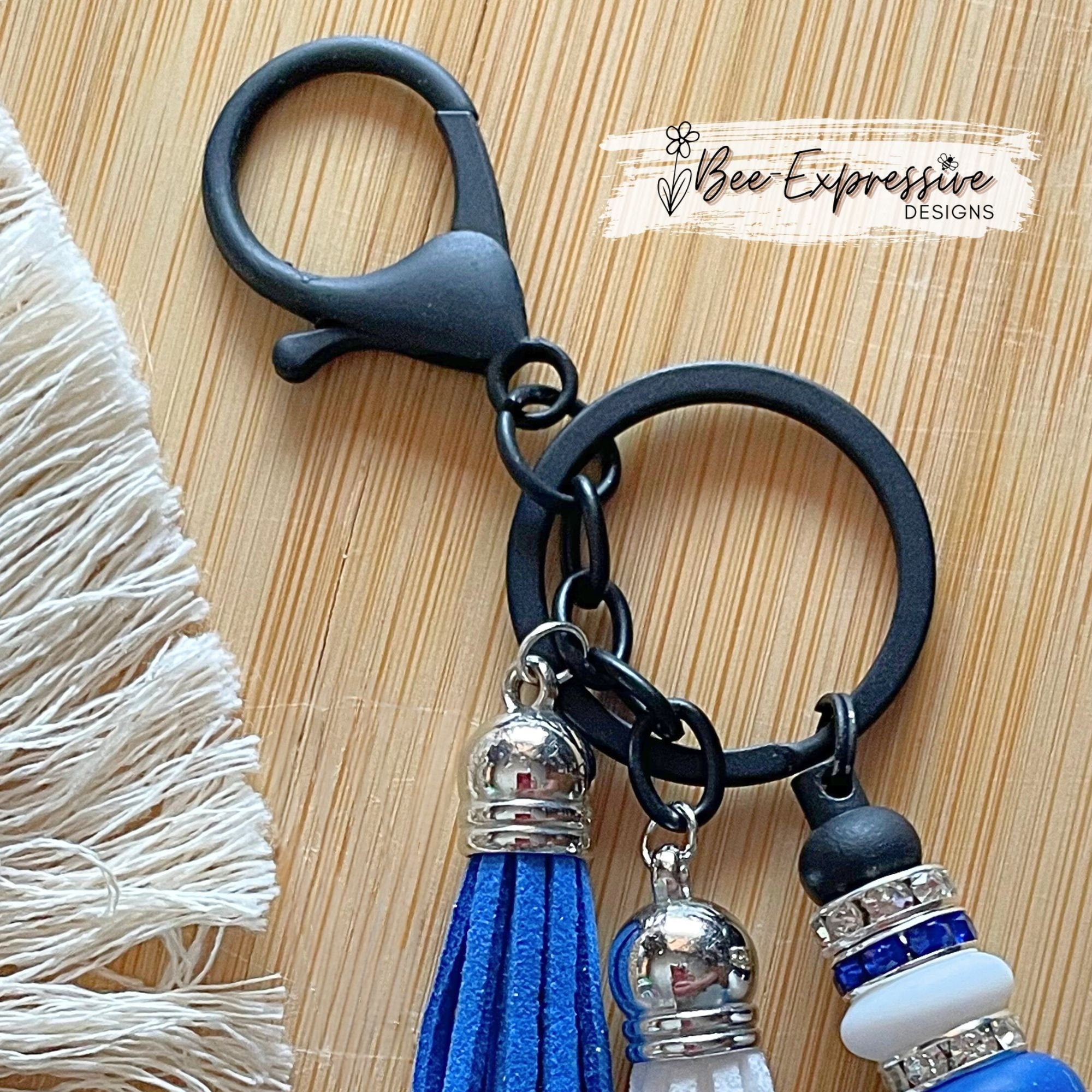Unique and handmade, blue silicone 4x4 vehicle, metal keychain with a black animal print bead, silicone lentil beads and rhinestone spacers!