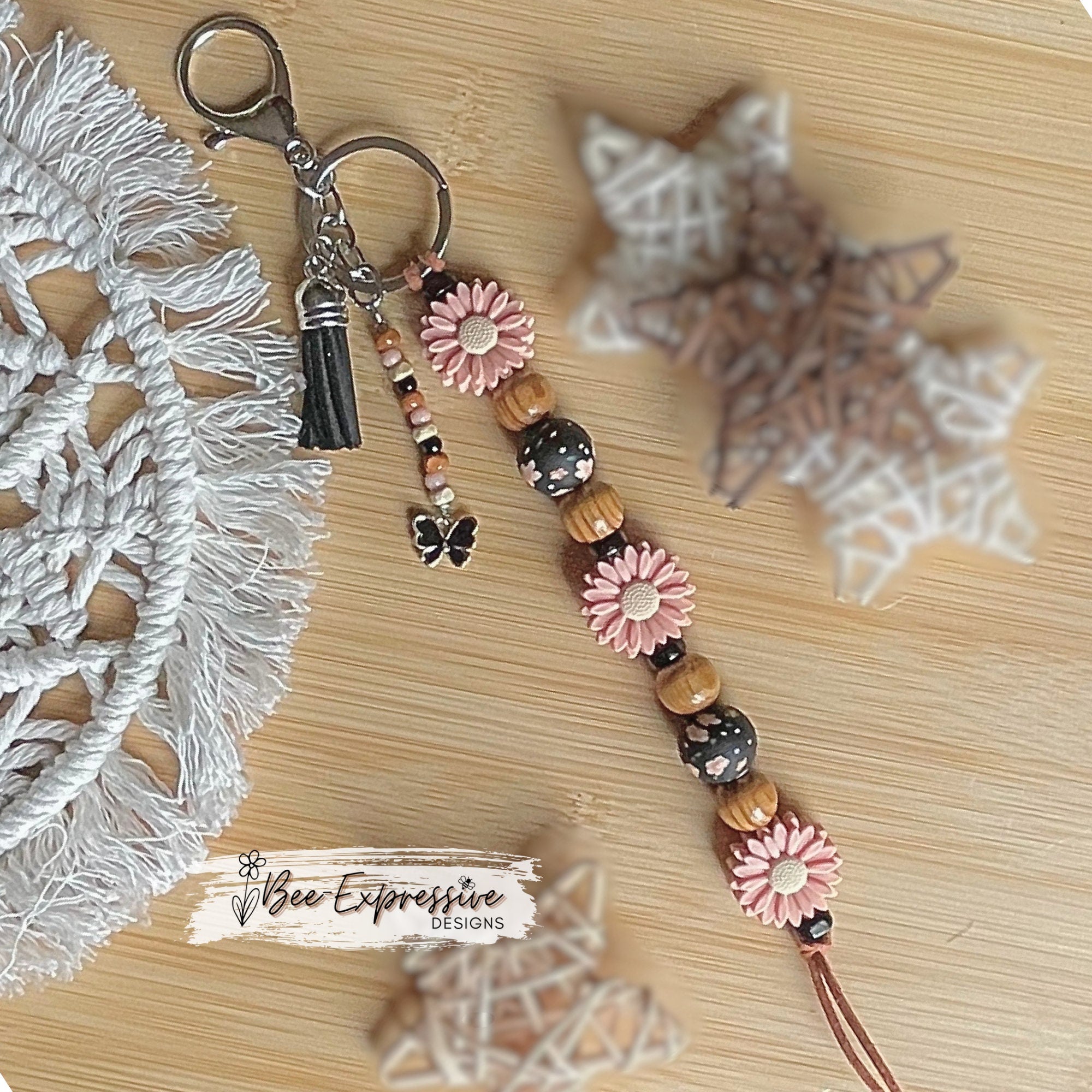 Beautiful, handmade  floral keychain!  Lobster claw clasp, suede cord, wood and silicone beads, beaded tassel with a butterfly charm pendant