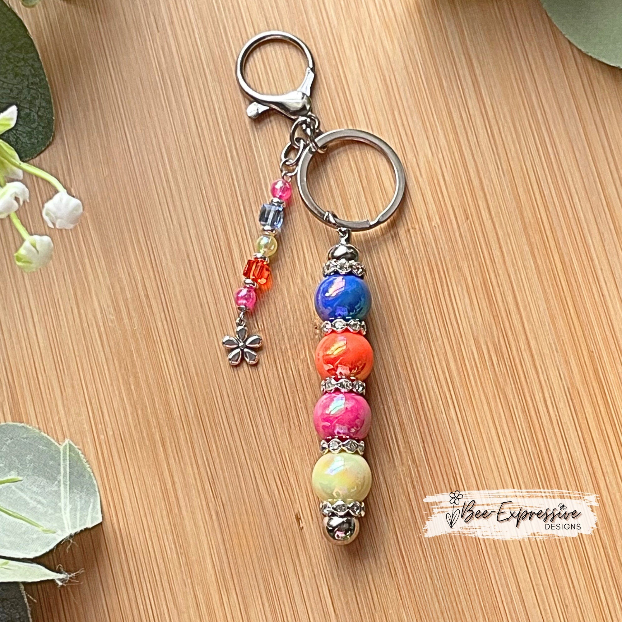 Beautiful, handmade keychain with iridescent beads! Lobster clasp, metal chain, rhinestone spacers, beaded tassel, metal flower charm!