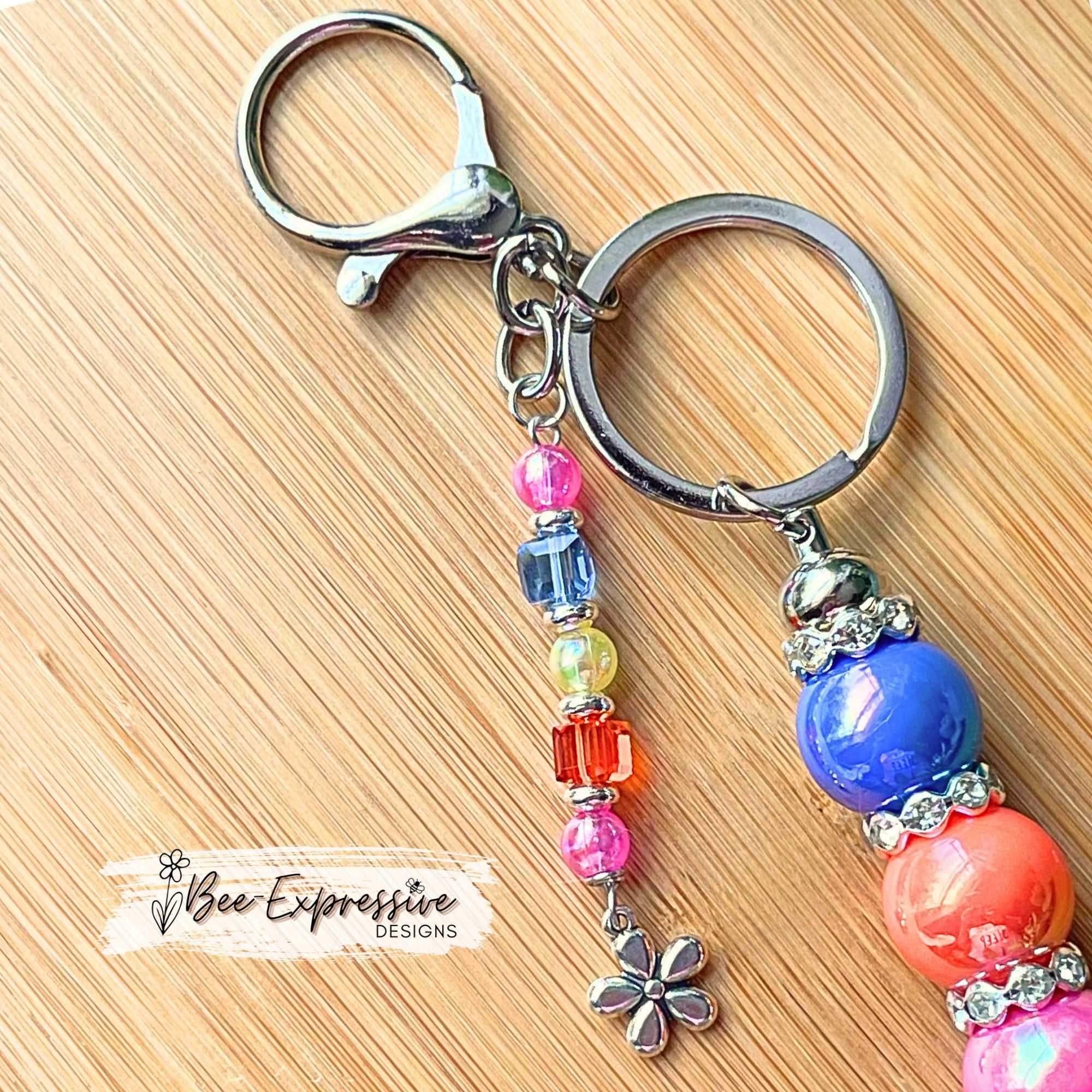 Beautiful, handmade keychain with iridescent beads! Lobster clasp, metal chain, rhinestone spacers, beaded tassel, metal flower charm!