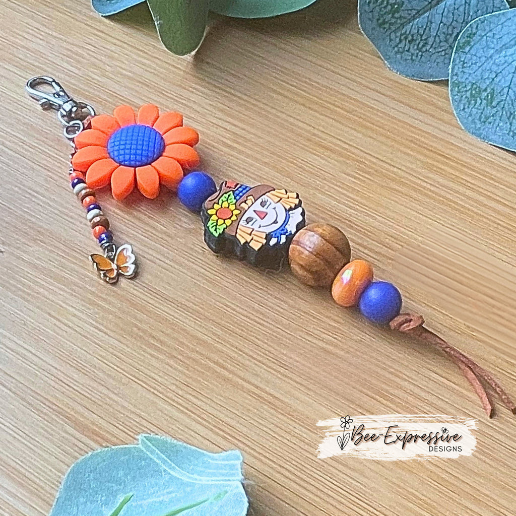 Adorable handmade, scarecrow keychain or bag chain!  Swivel or lobster clasp, cord, acrylic, silicone flower, beaded tassel, butterfly charm