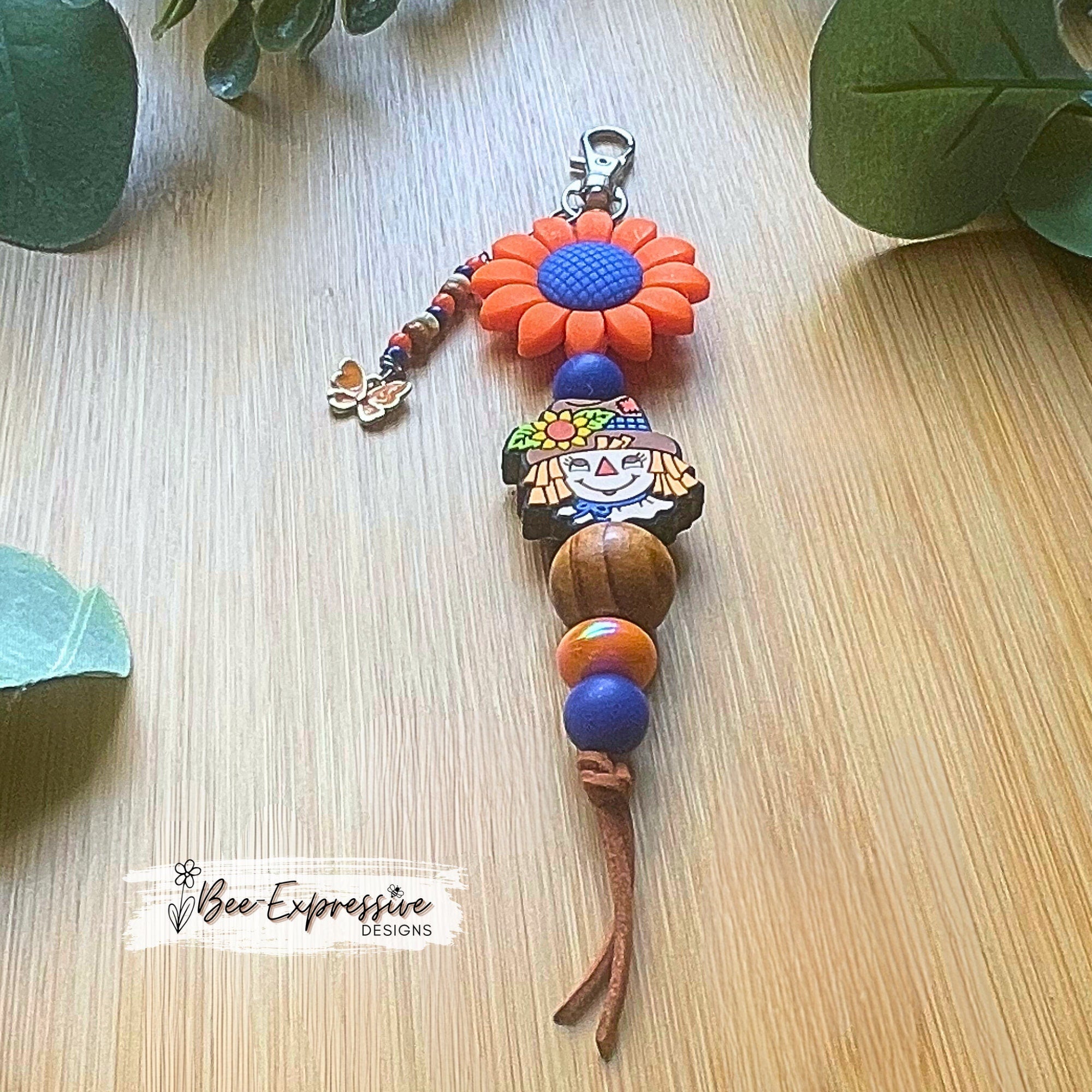 Adorable handmade, scarecrow keychain or bag chain!  Swivel or lobster clasp, cord, acrylic, silicone flower, beaded tassel, butterfly charm