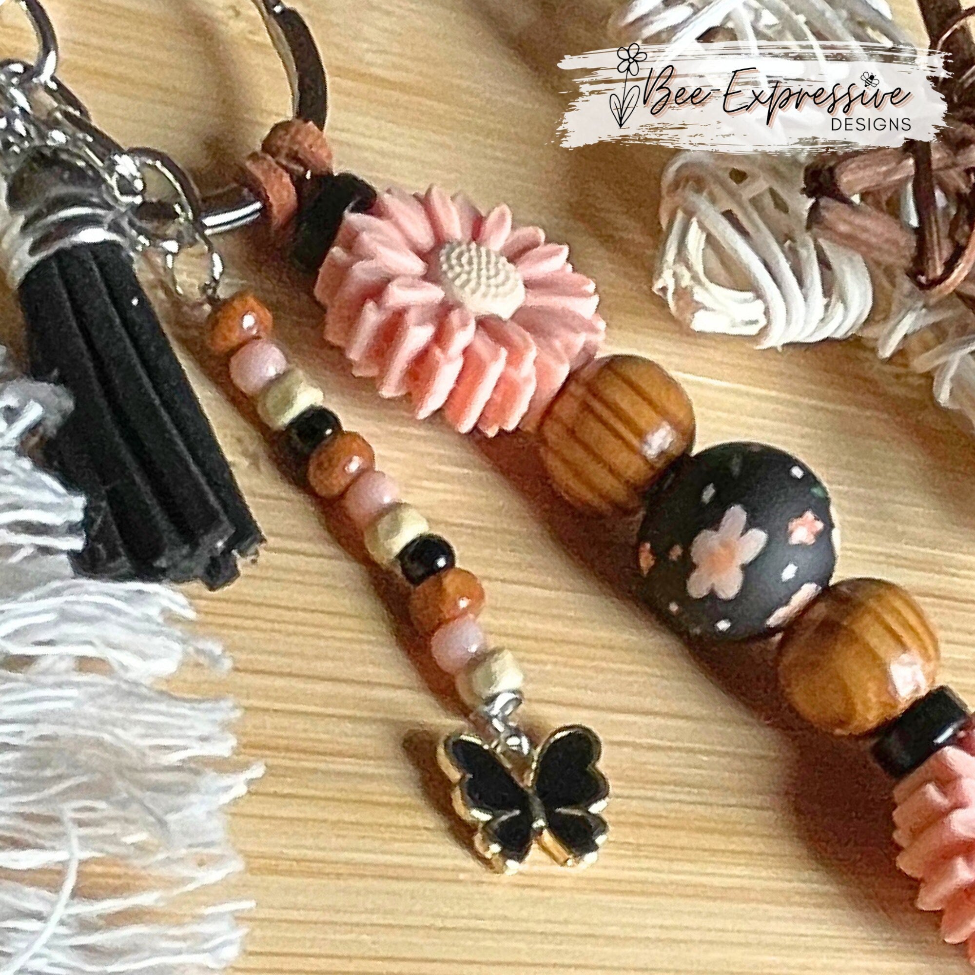 Beautiful, handmade  floral keychain!  Lobster claw clasp, suede cord, wood and silicone beads, beaded tassel with a butterfly charm pendant