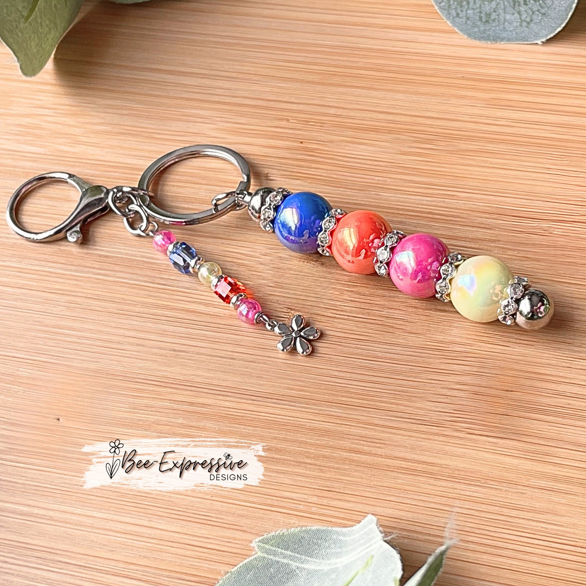 Beautiful, handmade keychain with iridescent beads! Lobster clasp, metal chain, rhinestone spacers, beaded tassel, metal flower charm!