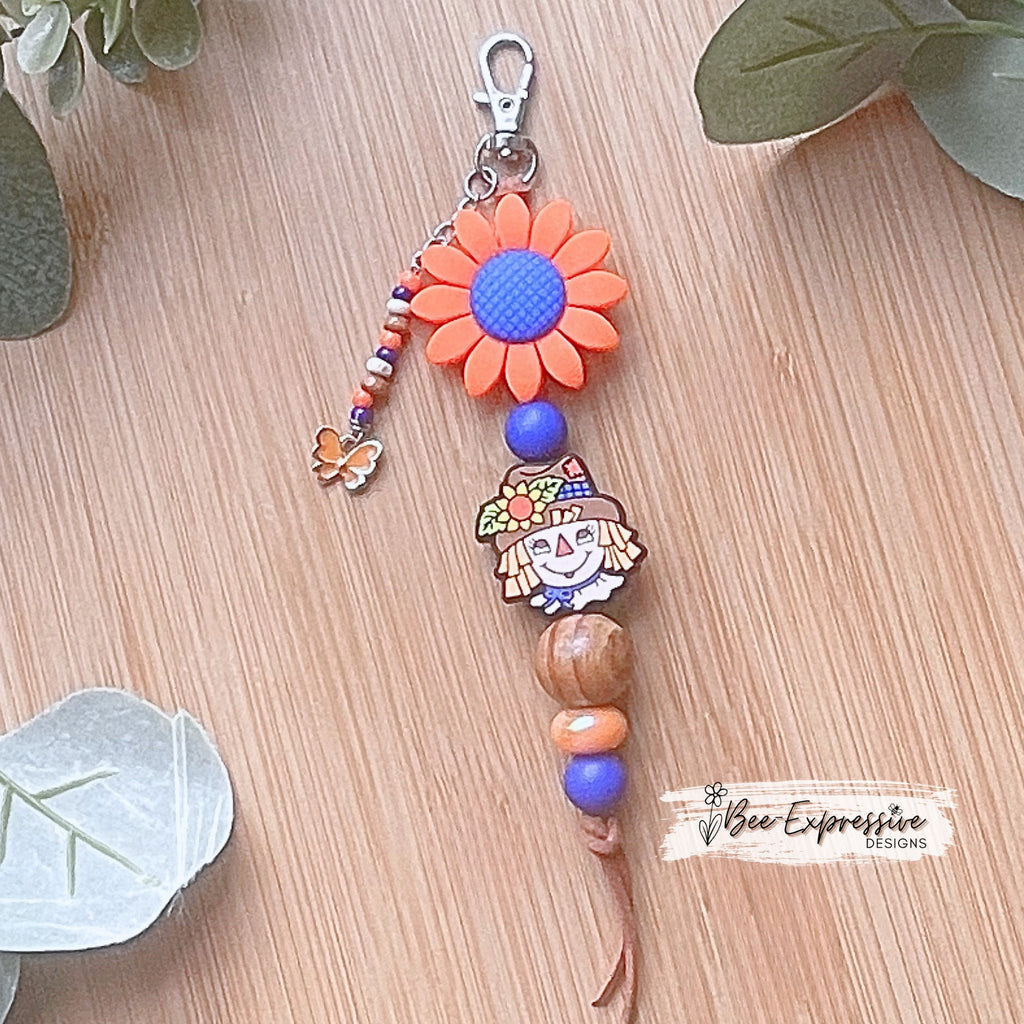 Adorable handmade, scarecrow keychain or bag chain!  Swivel or lobster clasp, cord, acrylic, silicone flower, beaded tassel, butterfly charm