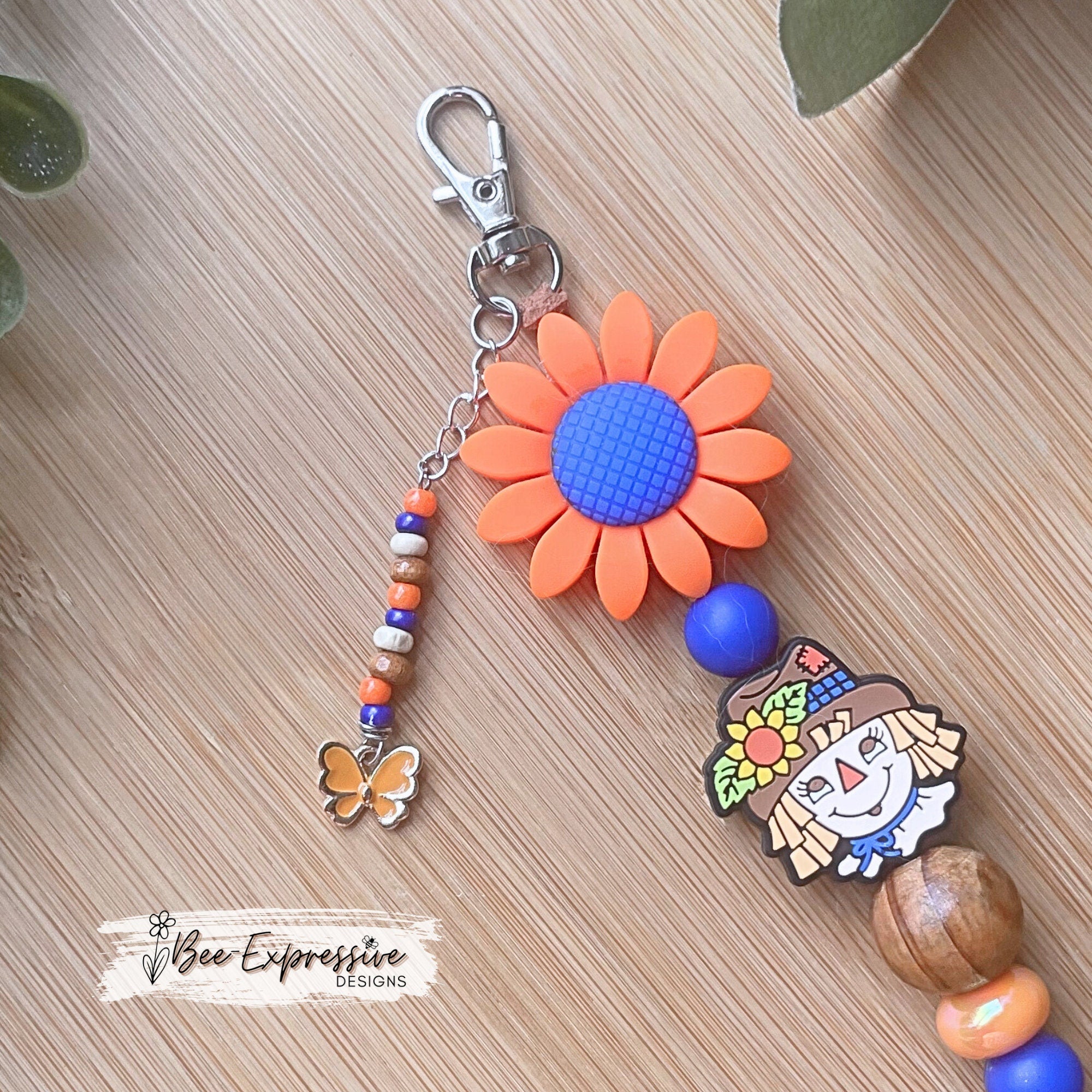 Adorable handmade, scarecrow keychain or bag chain!  Swivel or lobster clasp, cord, acrylic, silicone flower, beaded tassel, butterfly charm