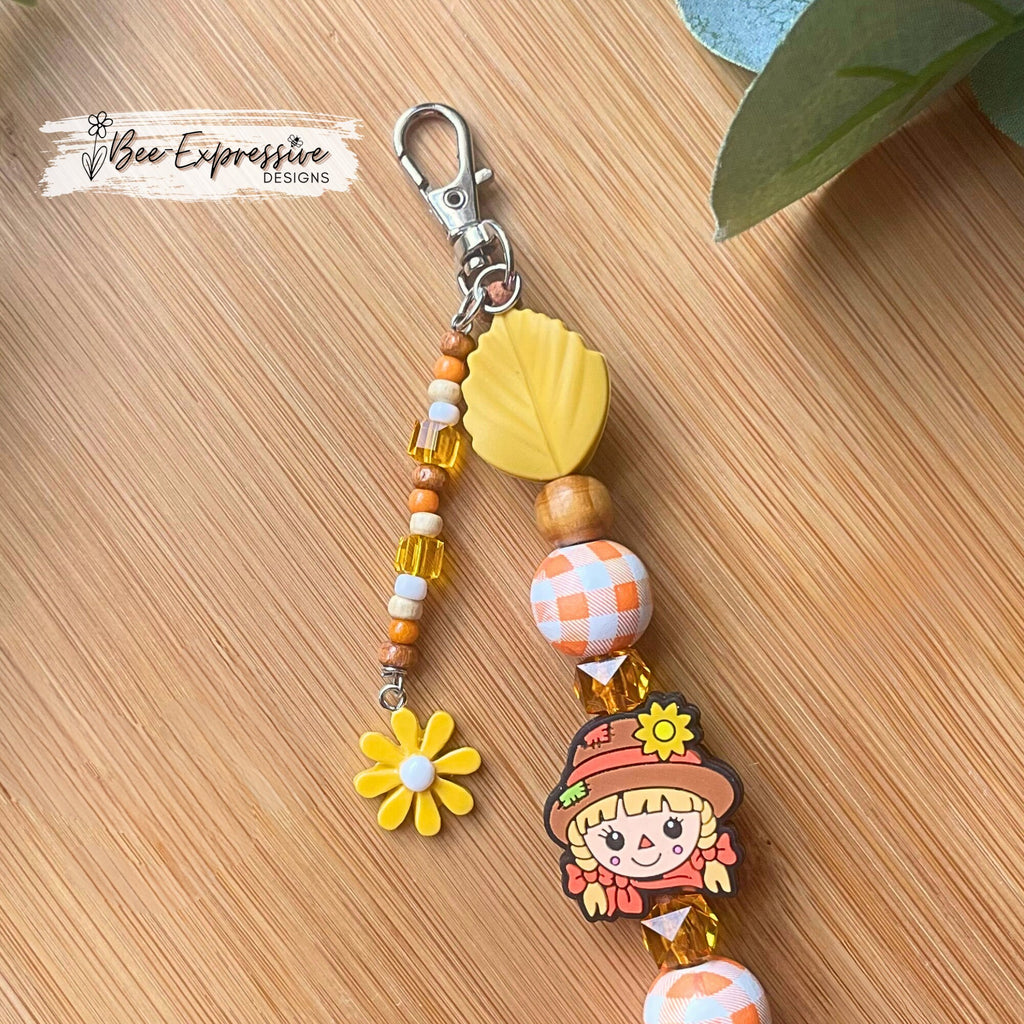 Handmade, beaded SCARECROW keychain! Swivel or lobster clasp, suede cord, silicone leaves, wood gingham, beaded tassel & flower charm!