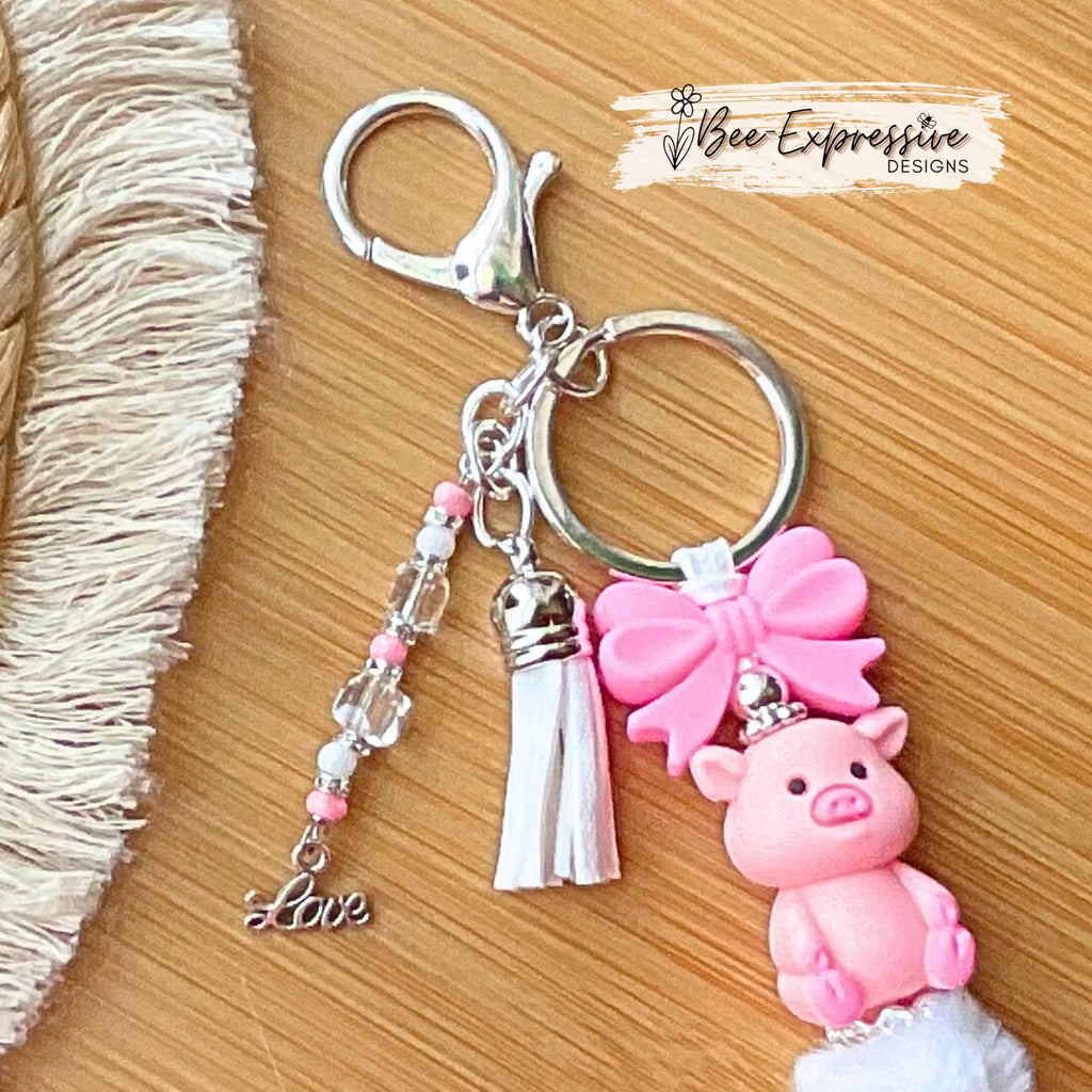 Beaded, 3D PIG keychain with a silicone pink bow! Lobster or swivel clasp, chunky rhinestone bead, fuzzy bead, beaded tassel & LOVE charm