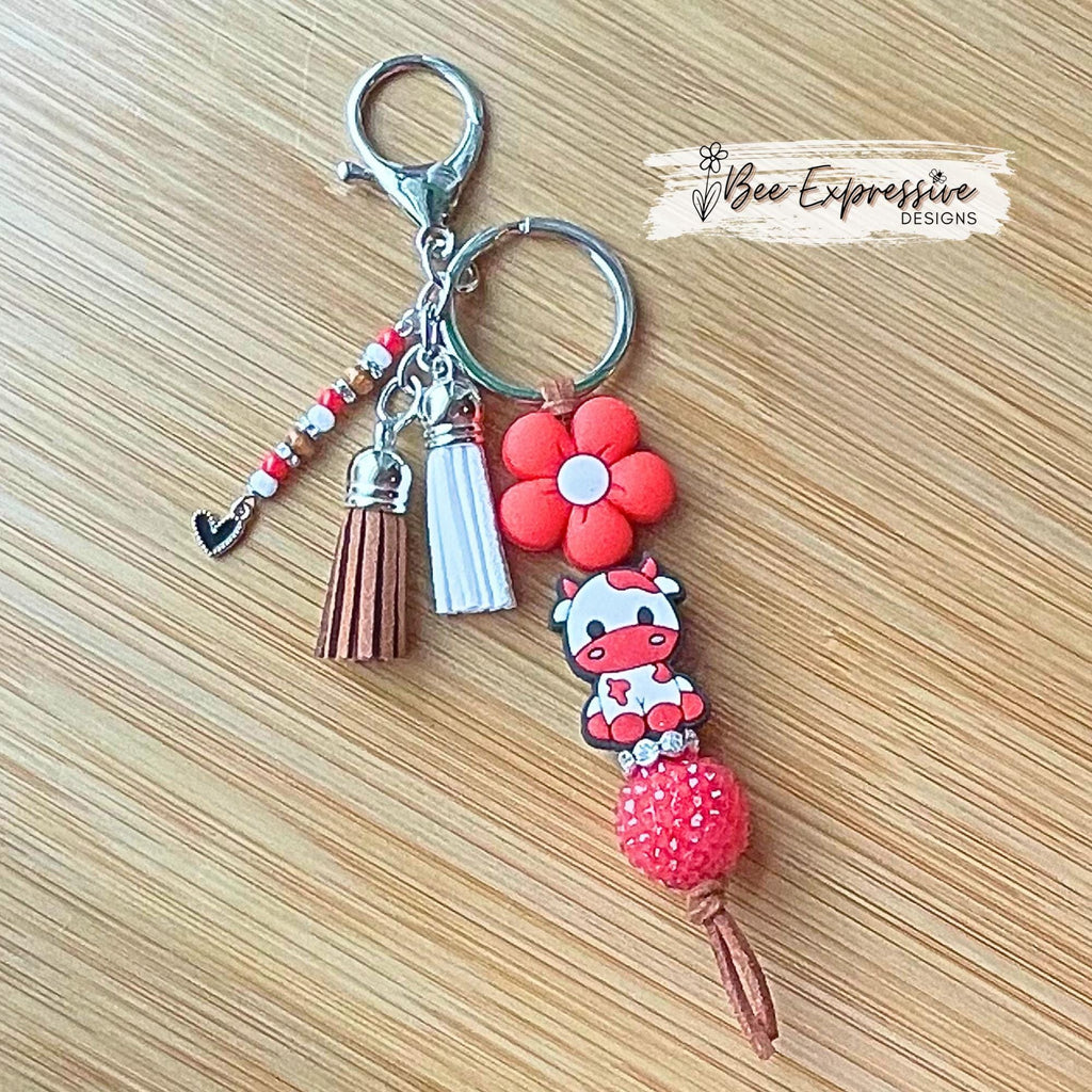 Handmade, RED COW keychain! Lobster or swivel clasp, suede cord chunky rhinestone bead, silicone daisy flower, beaded tassel w/ heart charm!