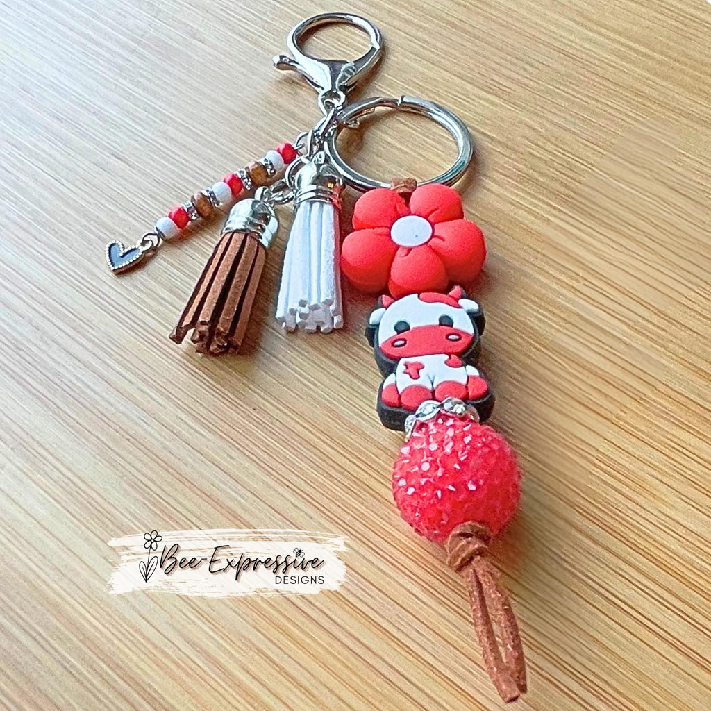 Handmade, RED COW keychain! Lobster or swivel clasp, suede cord chunky rhinestone bead, silicone daisy flower, beaded tassel w/ heart charm!