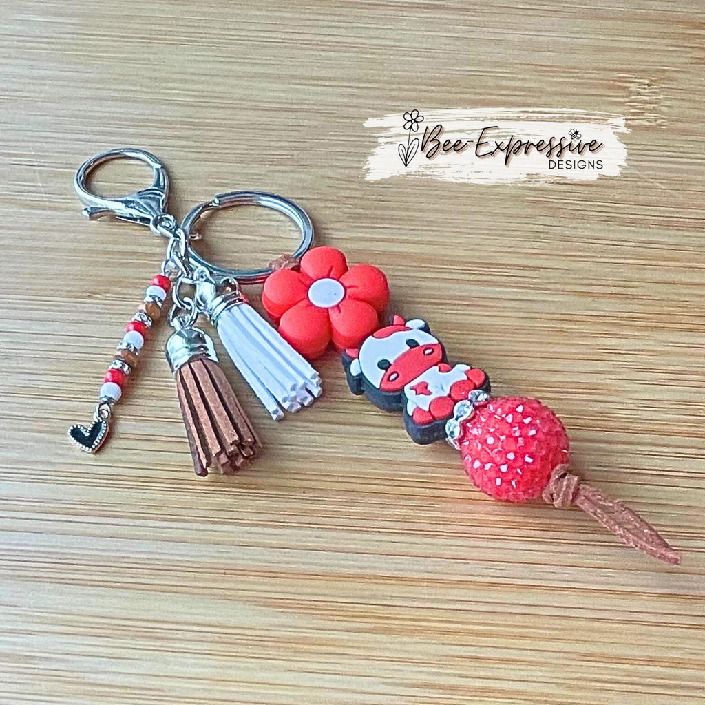 Handmade, RED COW keychain! Lobster or swivel clasp, suede cord chunky rhinestone bead, silicone daisy flower, beaded tassel w/ heart charm!