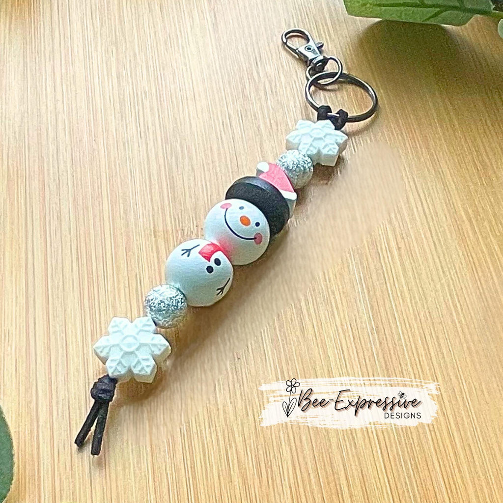 Adorable, handmade, Christmas WOOD snowman keychain! Lobster swivel clasp, keyring, suede cord, printed wood beads, silicone snowflake beads
