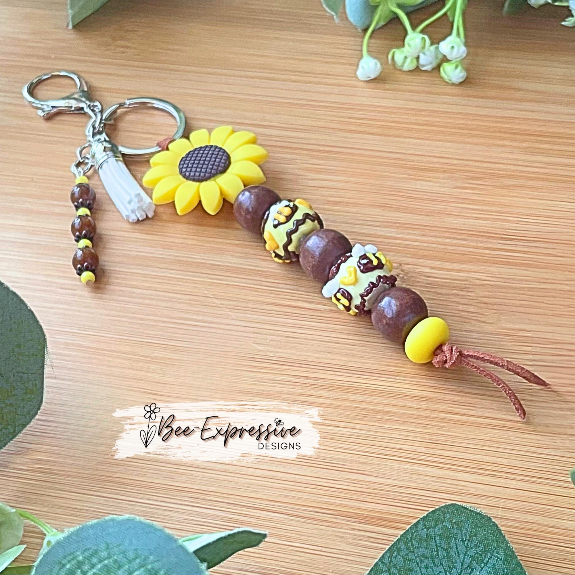 Beautiful, beaded, handmade, silicone SUNFLOWER bee keychain! Lobster clasp, suede cord, lampwork and wood beads, beaded acrylic tassel
