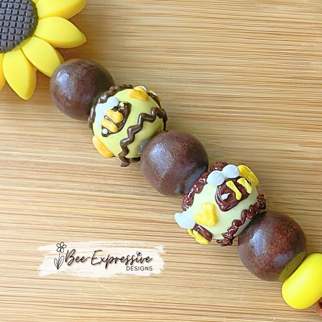 Beautiful, beaded, handmade, silicone SUNFLOWER bee keychain! Lobster clasp, suede cord, lampwork and wood beads, beaded acrylic tassel