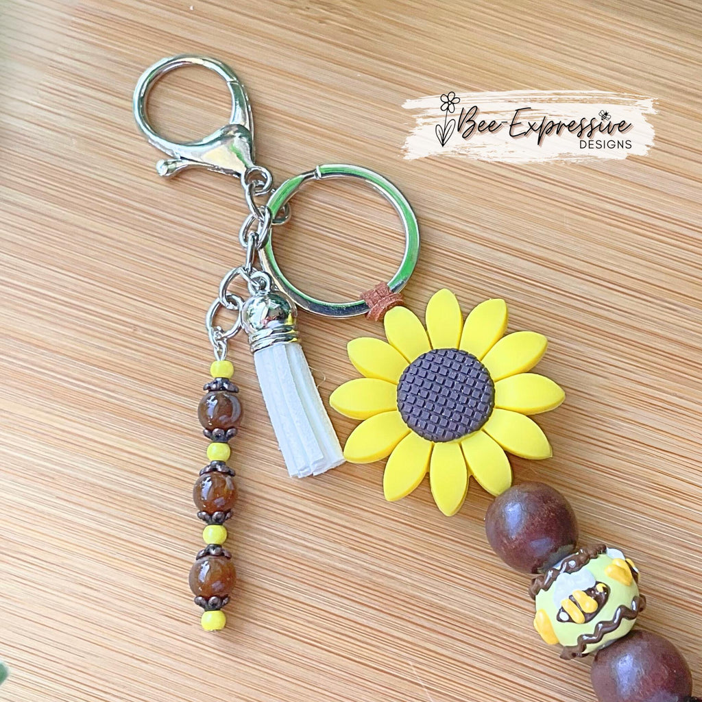 Beautiful, beaded, handmade, silicone SUNFLOWER bee keychain! Lobster clasp, suede cord, lampwork and wood beads, beaded acrylic tassel