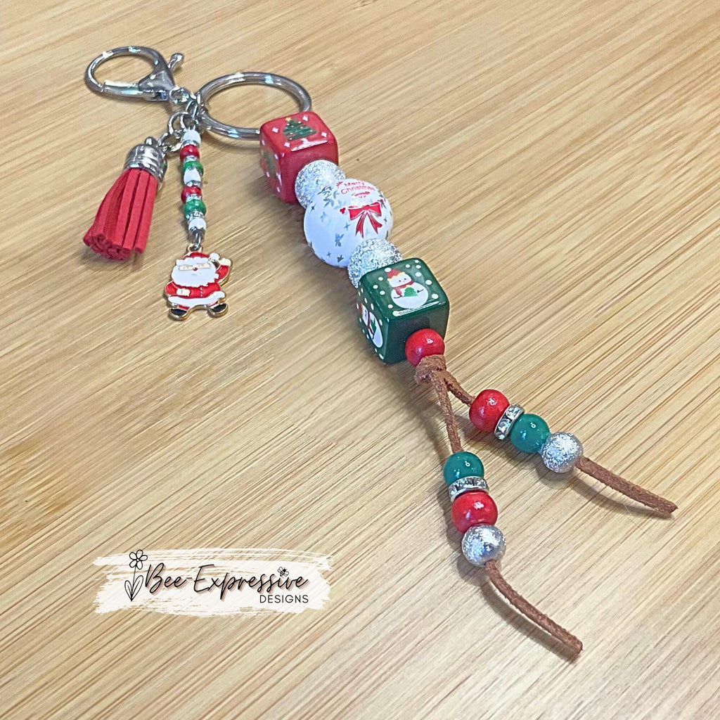 Adorable, handmade, square beaded, Christmas keychain!  Lobster clasp, suede cord, acrylic & wood beads, beaded tassel, Santa charm