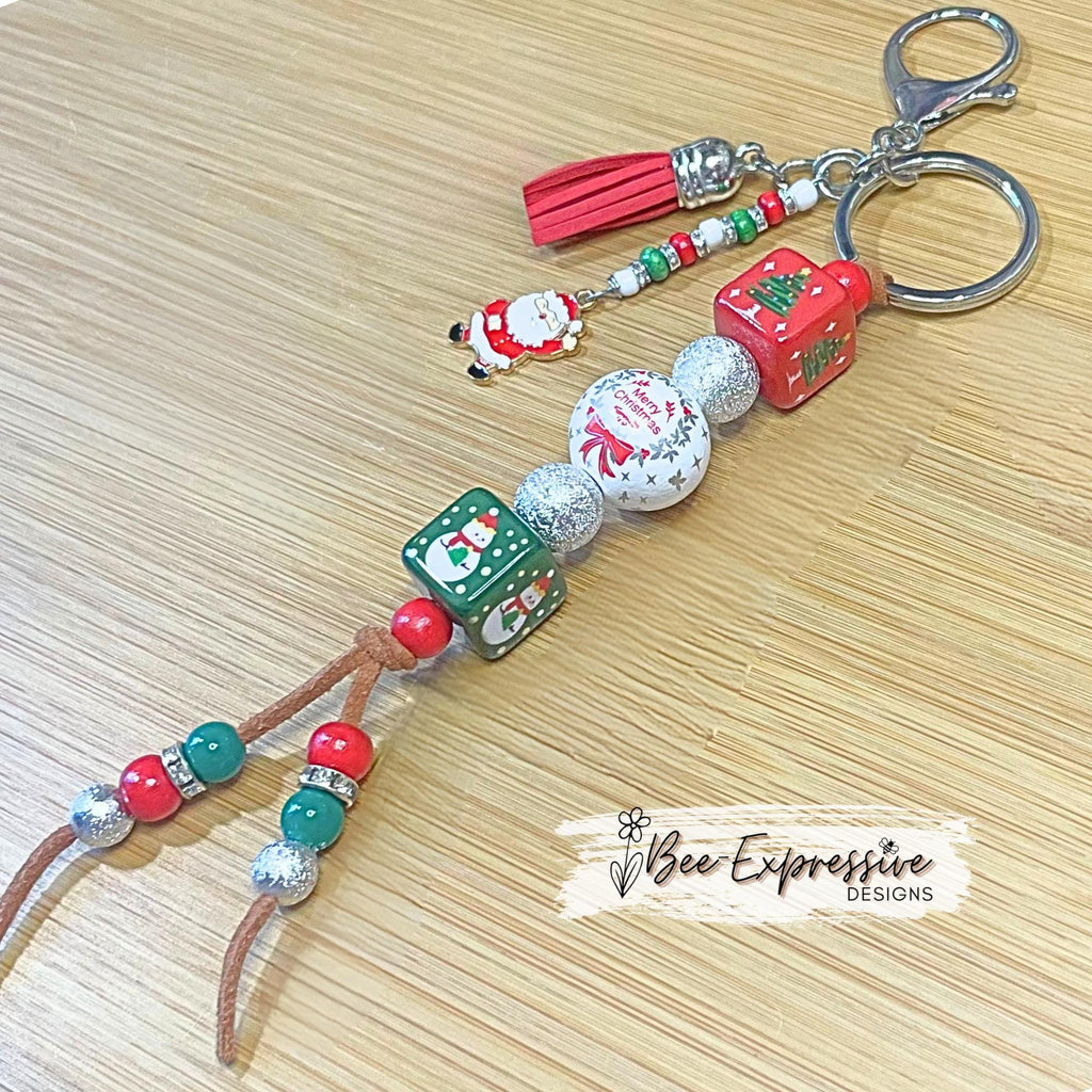 Adorable, handmade, square beaded, Christmas keychain!  Lobster clasp, suede cord, acrylic & wood beads, beaded tassel, Santa charm