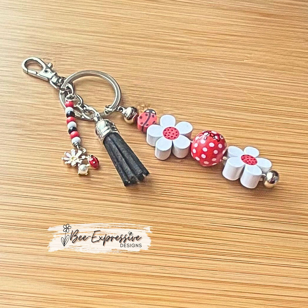 Handmade, beaded, lady bug keychain! Lobster or swivel clasp, wood daisy flowers, polka dot bead, and a beaded tassel with a lady bug charm