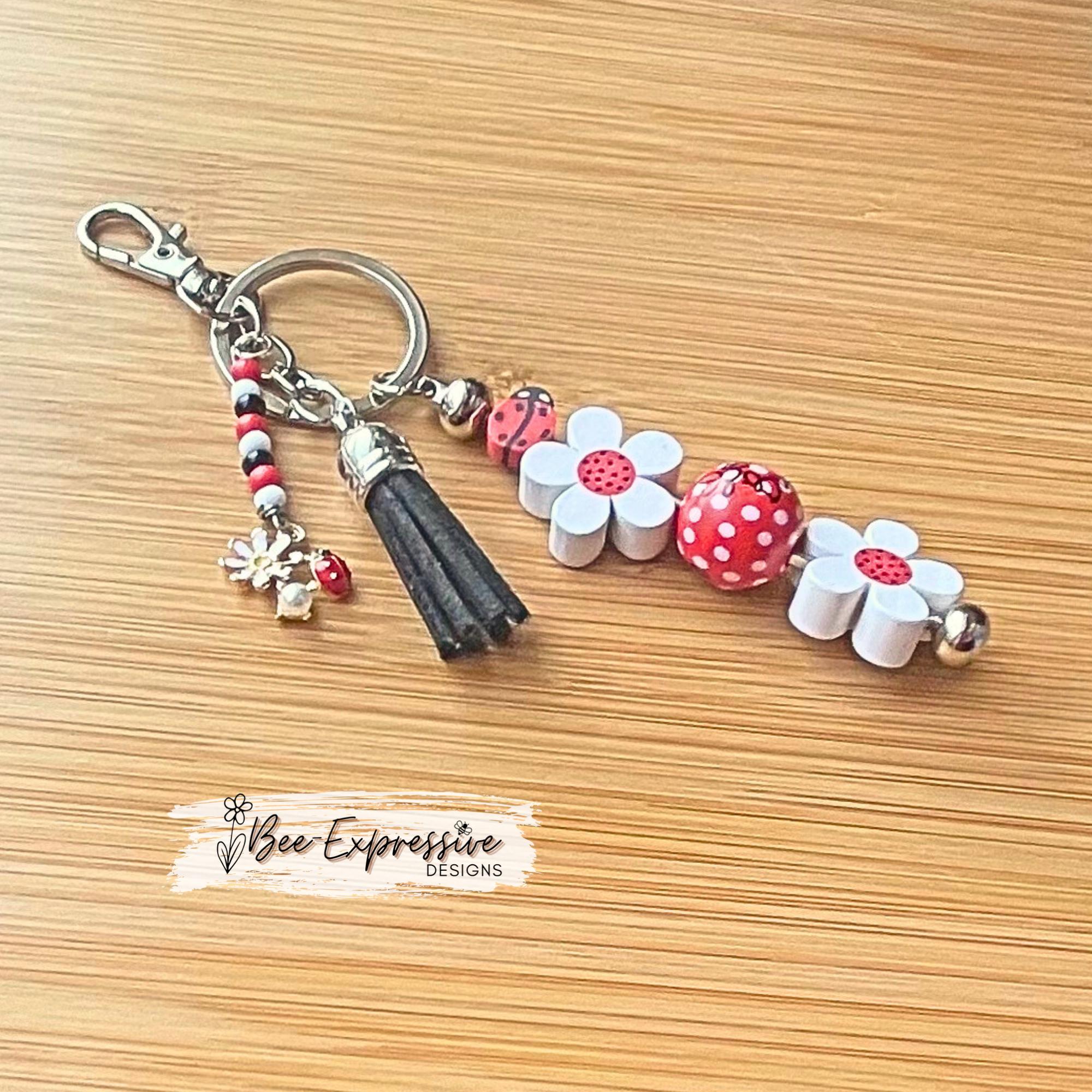Handmade, beaded, lady bug keychain! Lobster or swivel clasp, wood daisy flowers, polka dot bead, and a beaded tassel with a lady bug charm