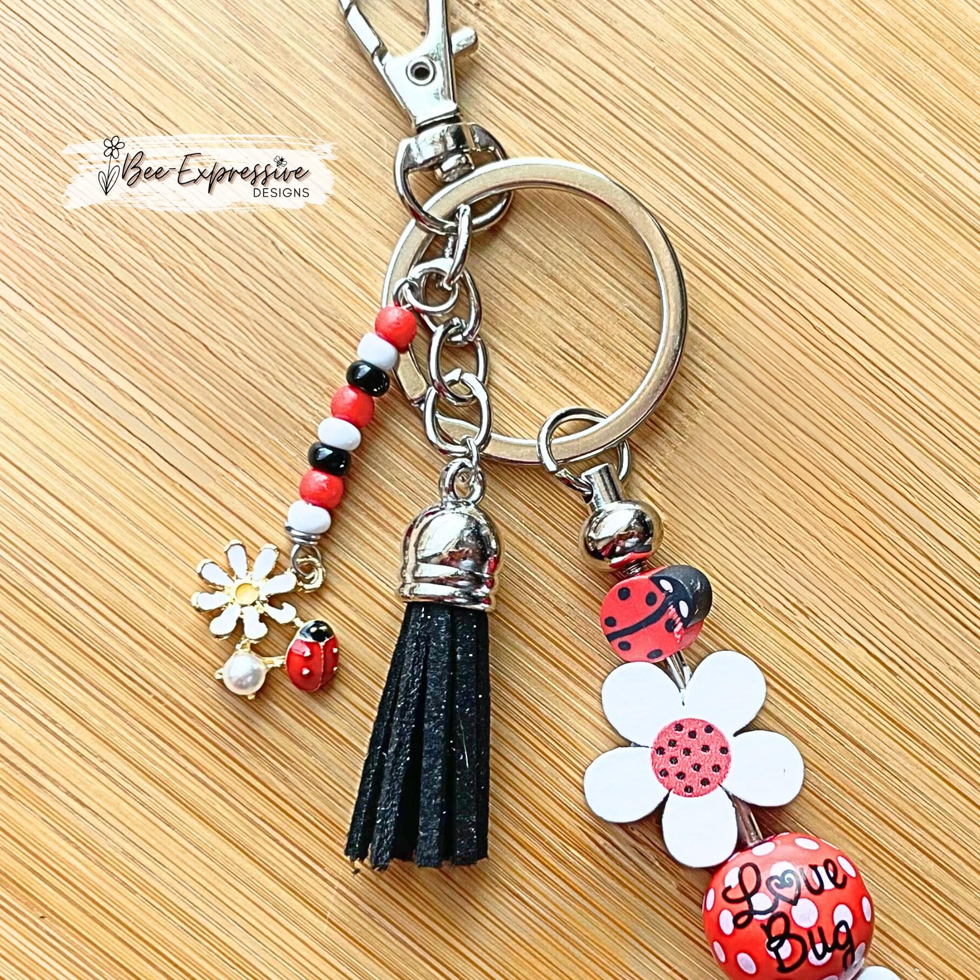 Handmade, beaded, lady bug keychain! Lobster or swivel clasp, wood daisy flowers, polka dot bead, and a beaded tassel with a lady bug charm