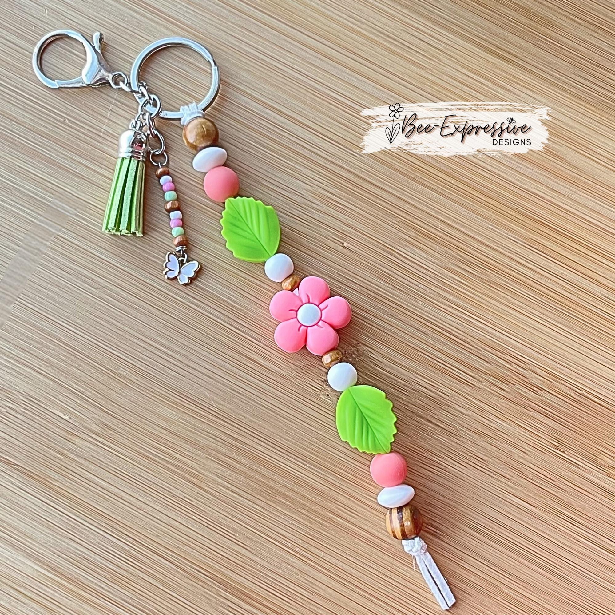 Beautiful handmade silicone DAISY floral keychain! Lobster or swivel clasp, silicone leaves, wood beads, beaded tassel with butterfly charm!