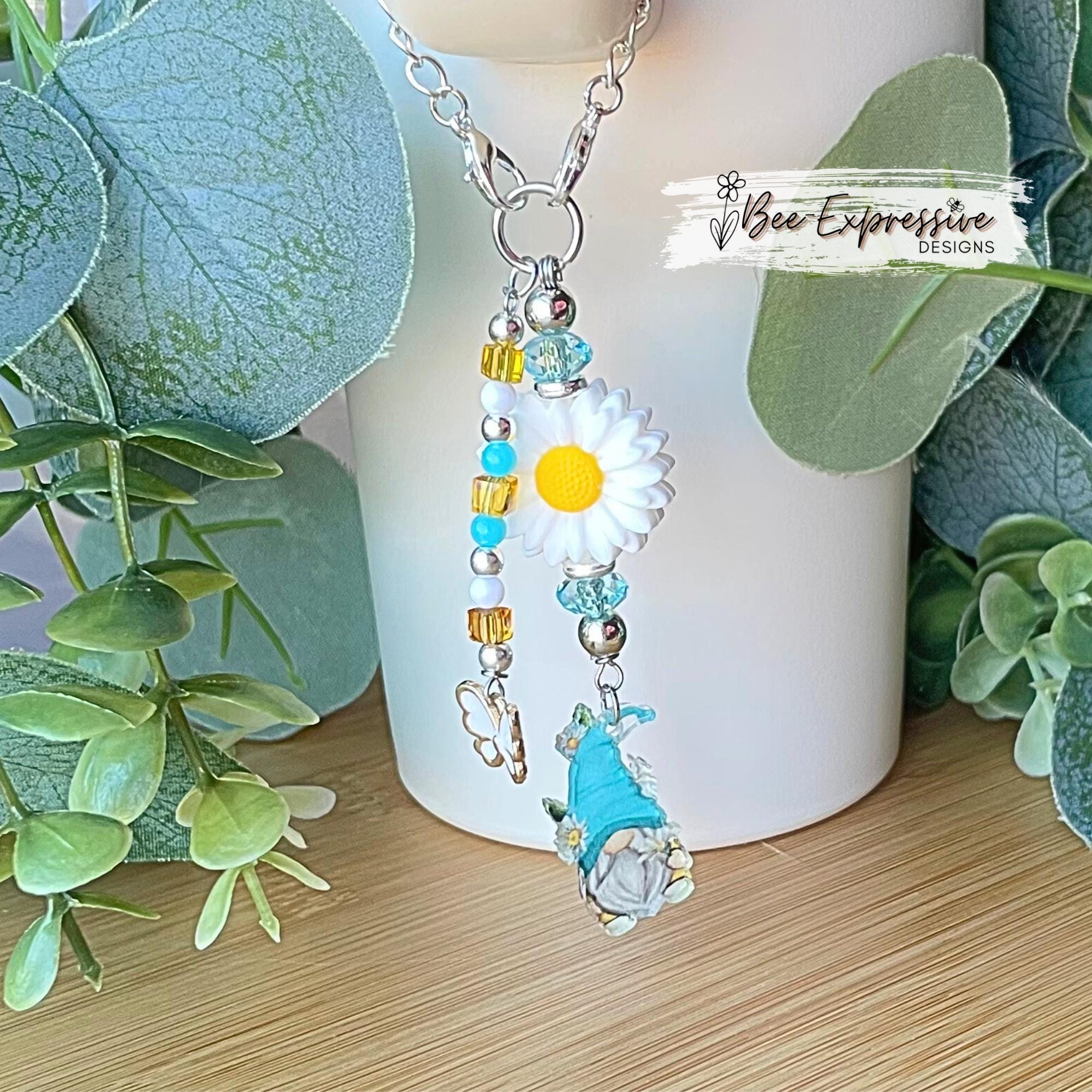 Acrylic gnome charm and silicone daisy flower, tumbler charm chain! Beaded tassel with transparent beads and white butterfly charm pendant!