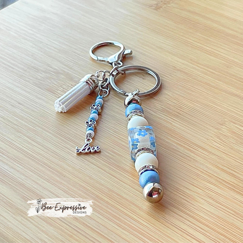 Beaded, baby blue & white, keychain! Lobster or swivel clasp, wood and acrylic beads, beaded tassel with silver flowers and a LOVE charm