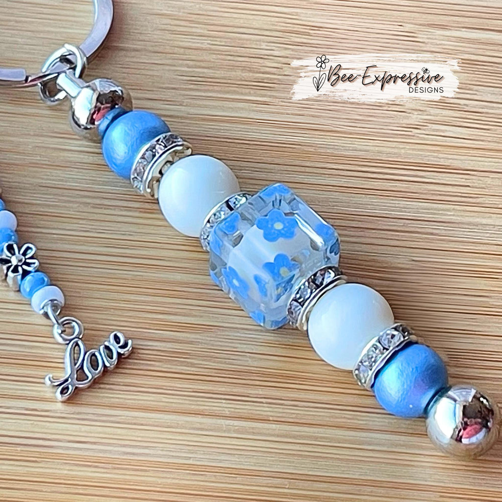 Beaded, baby blue & white, keychain! Lobster or swivel clasp, wood and acrylic beads, beaded tassel with silver flowers and a LOVE charm