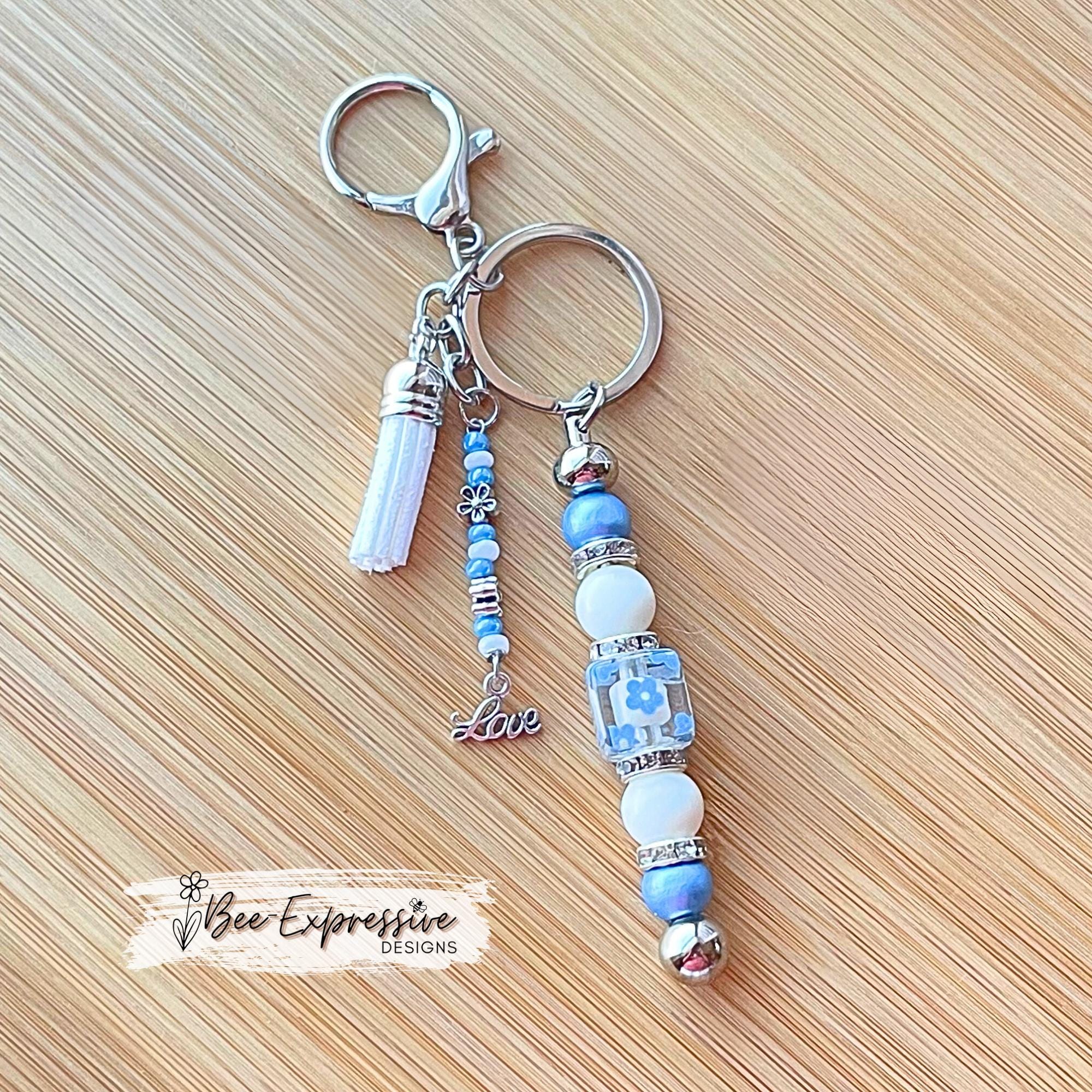 Beaded, baby blue & white, keychain! Lobster or swivel clasp, wood and acrylic beads, beaded tassel with silver flowers and a LOVE charm