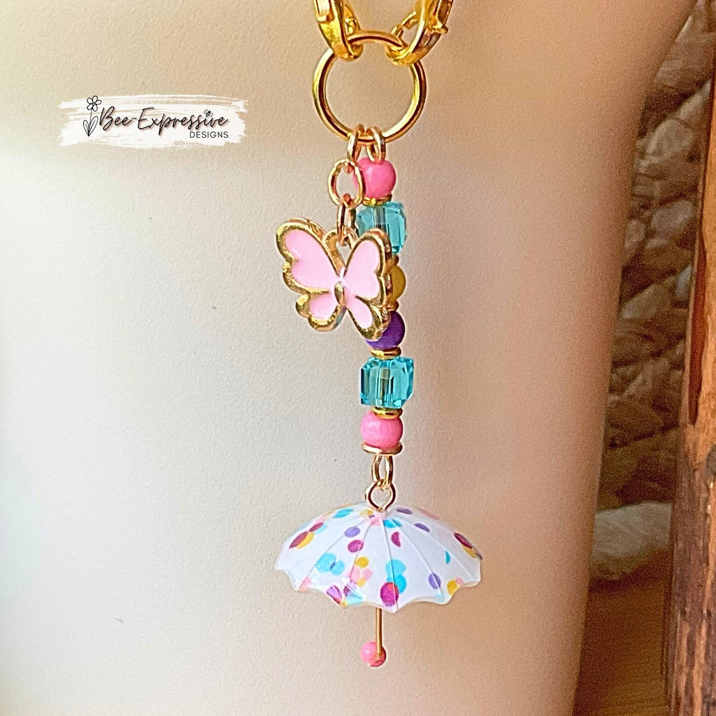 Beaded, umbrella charm chain for the Stanley tumbler! Acrylic beads, gold toned spacers, pink butterfly charm, lobster clasps, polka dots!