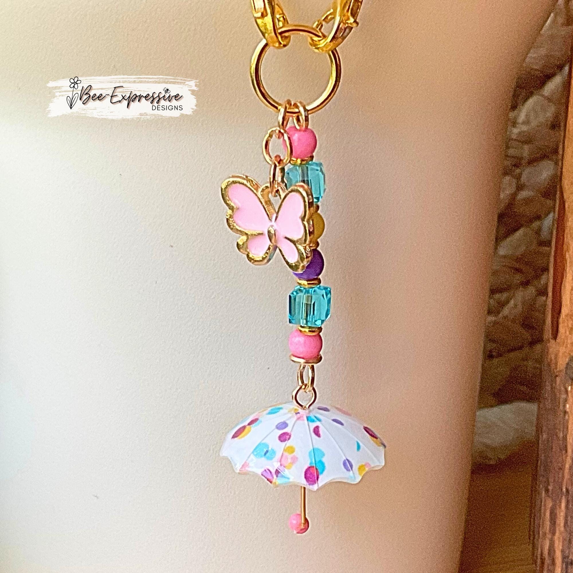 Beaded, umbrella charm chain for the Stanley tumbler! Acrylic beads, gold toned spacers, pink butterfly charm, lobster clasps, polka dots!