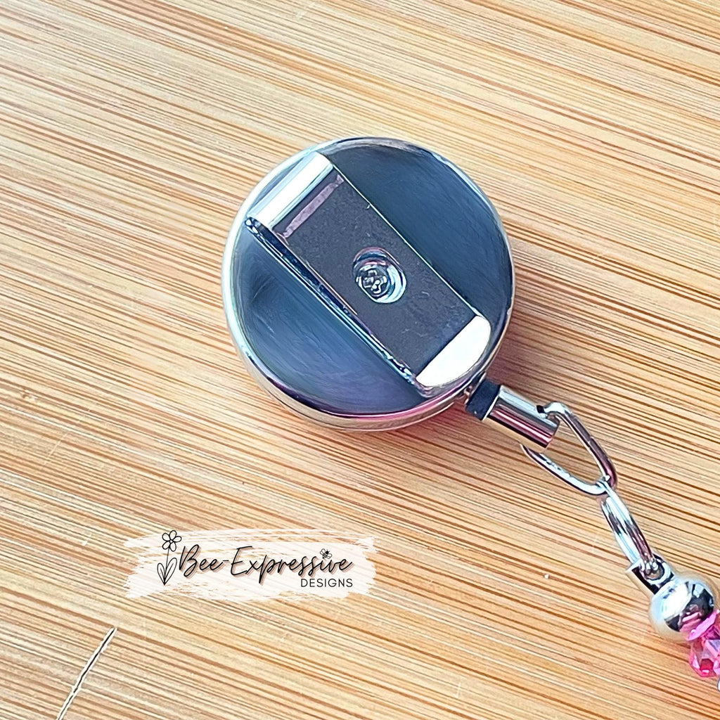 Unique, beaded, DD donut badge reel!  Metal clip and pull cable, silicone donut appliqué, a beaded bar with acrylic beads, spacers!