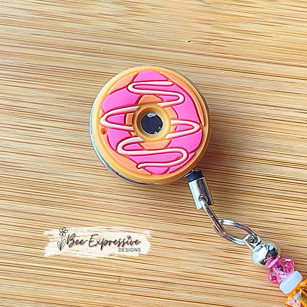 Unique, beaded, DD donut badge reel!  Metal clip and pull cable, silicone donut appliqué, a beaded bar with acrylic beads, spacers!