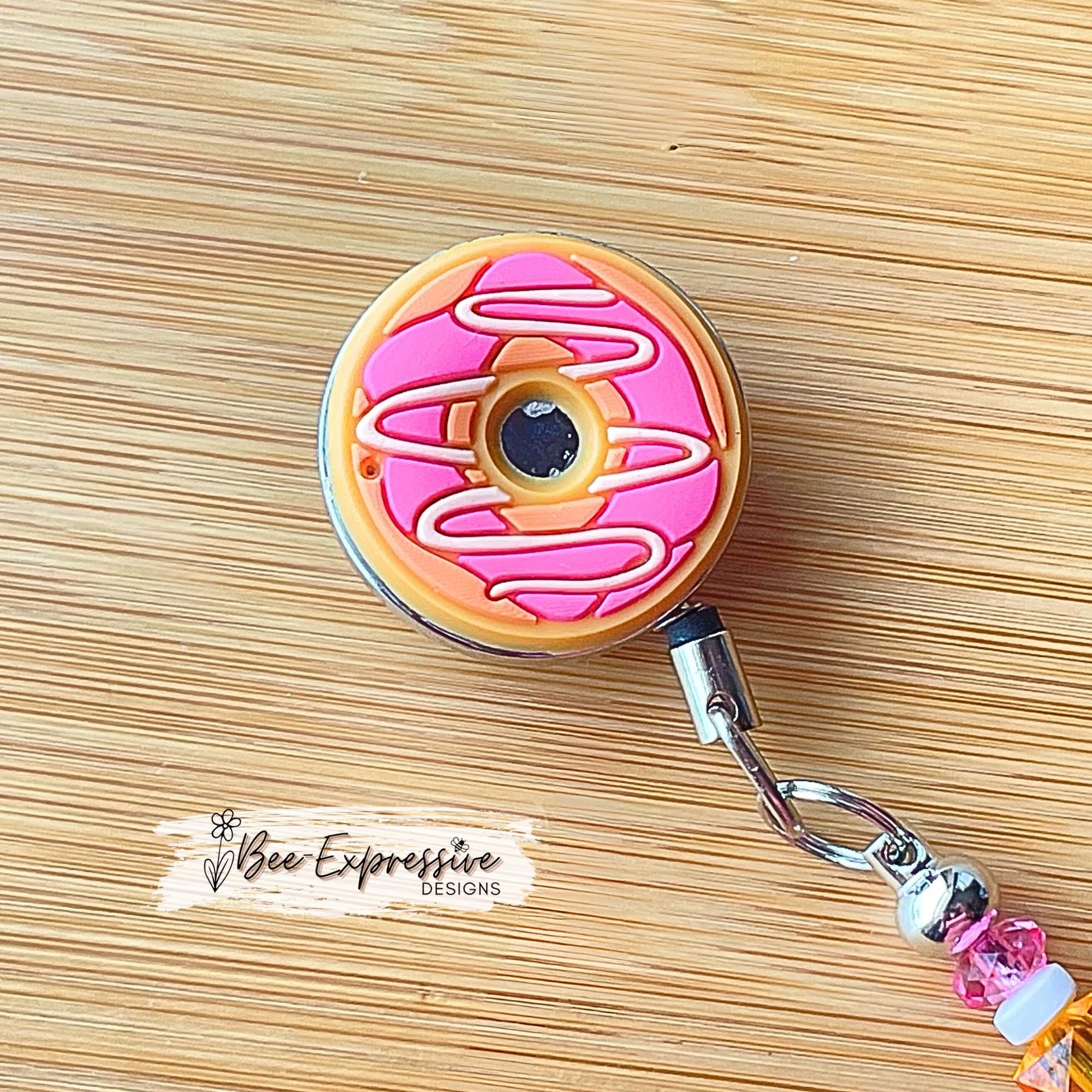 Unique, beaded, DD donut badge reel!  Metal clip and pull cable, silicone donut appliqué, a beaded bar with acrylic beads, spacers!