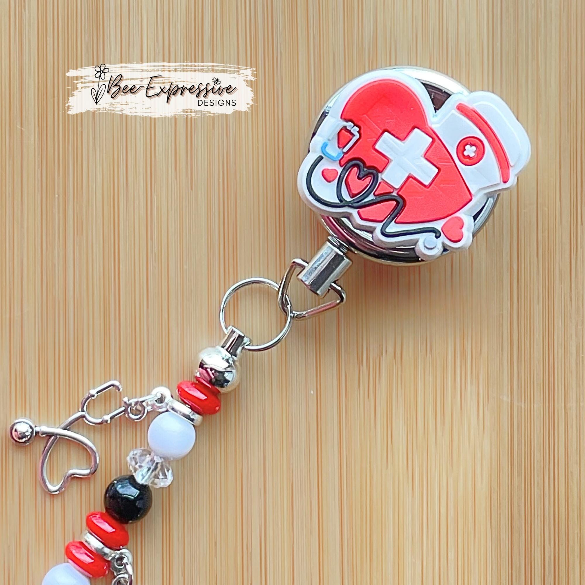 Nurse, beaded badge reel! Metal clip and pull cable, silicone nurse appliqué, a beaded bar with acrylic beads, stethoscope & heart charms!