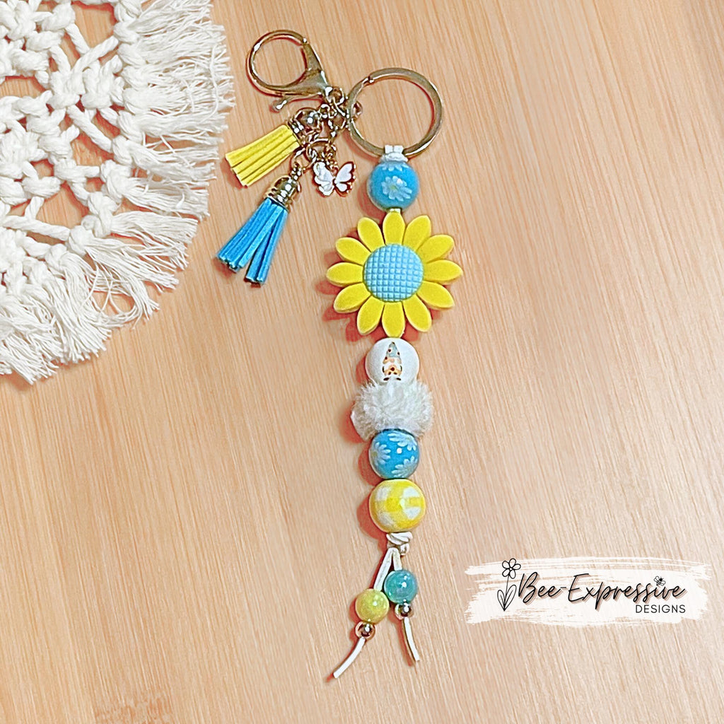 Beaded, silicone SUNFLOWER gnome keychain! Lobster or swivel clasp, suede cord, floral wood beads, furry bead, tassels, butterfly charm!