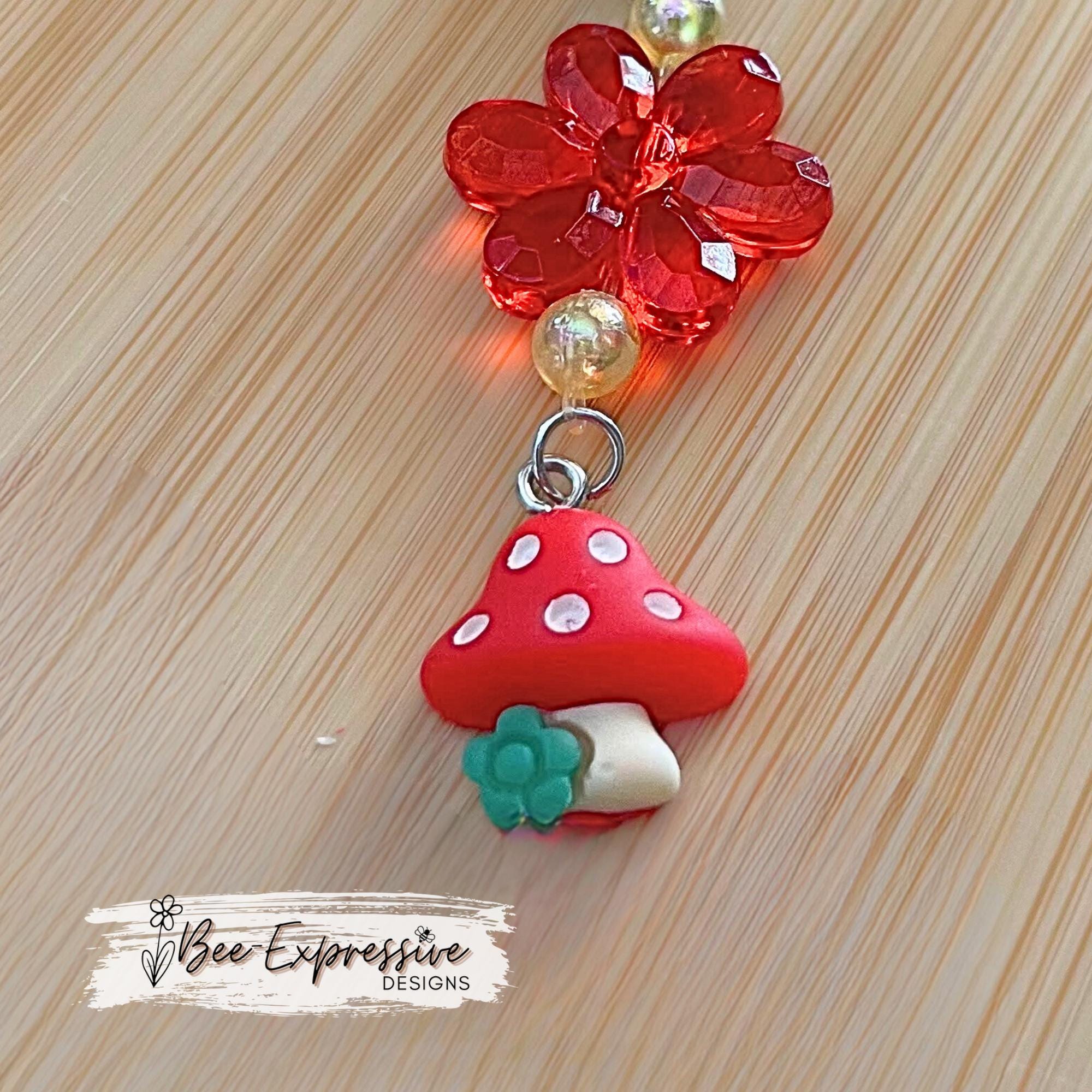 Beautiful, handmade keychain with transparent acrylic flower beads, yellow faux pearl beads, rhinestone spacers and red mushroom charm!