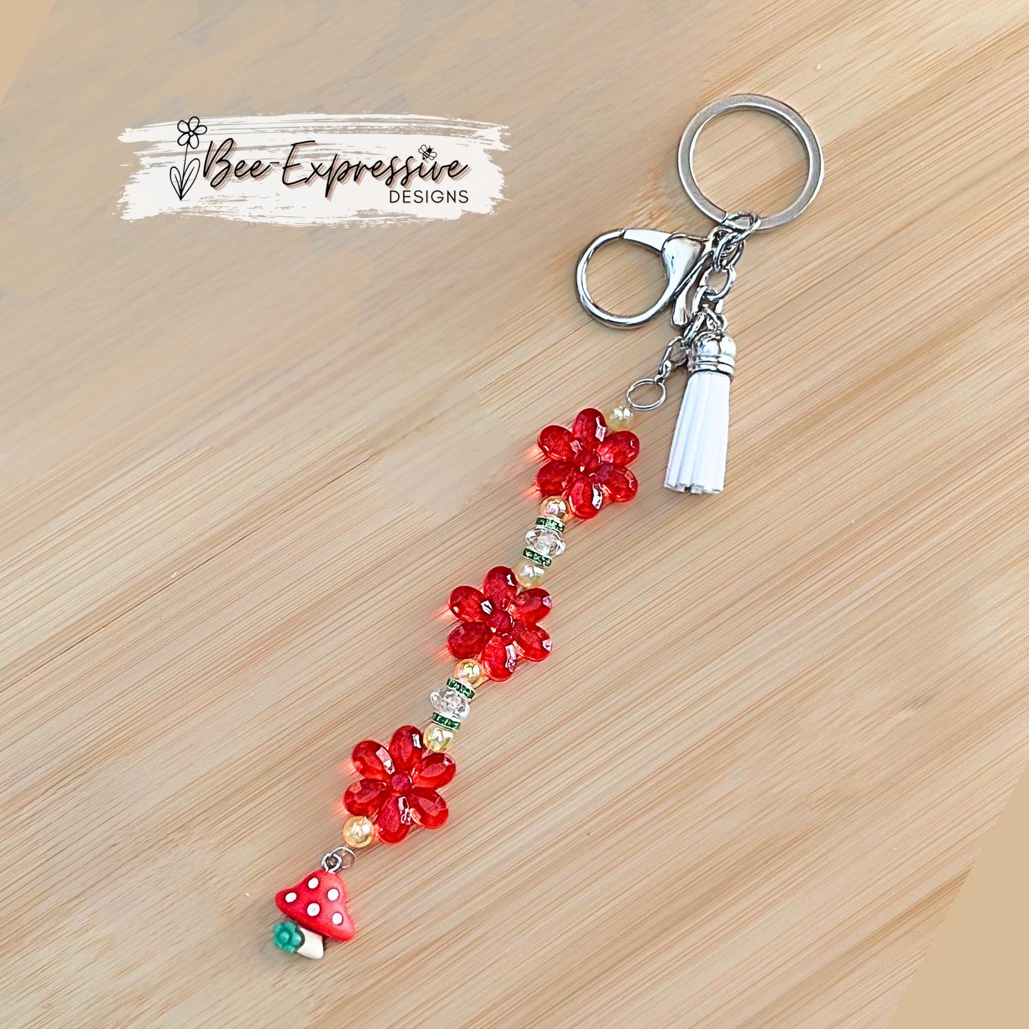 Beautiful, handmade keychain with transparent acrylic flower beads, yellow faux pearl beads, rhinestone spacers and red mushroom charm!