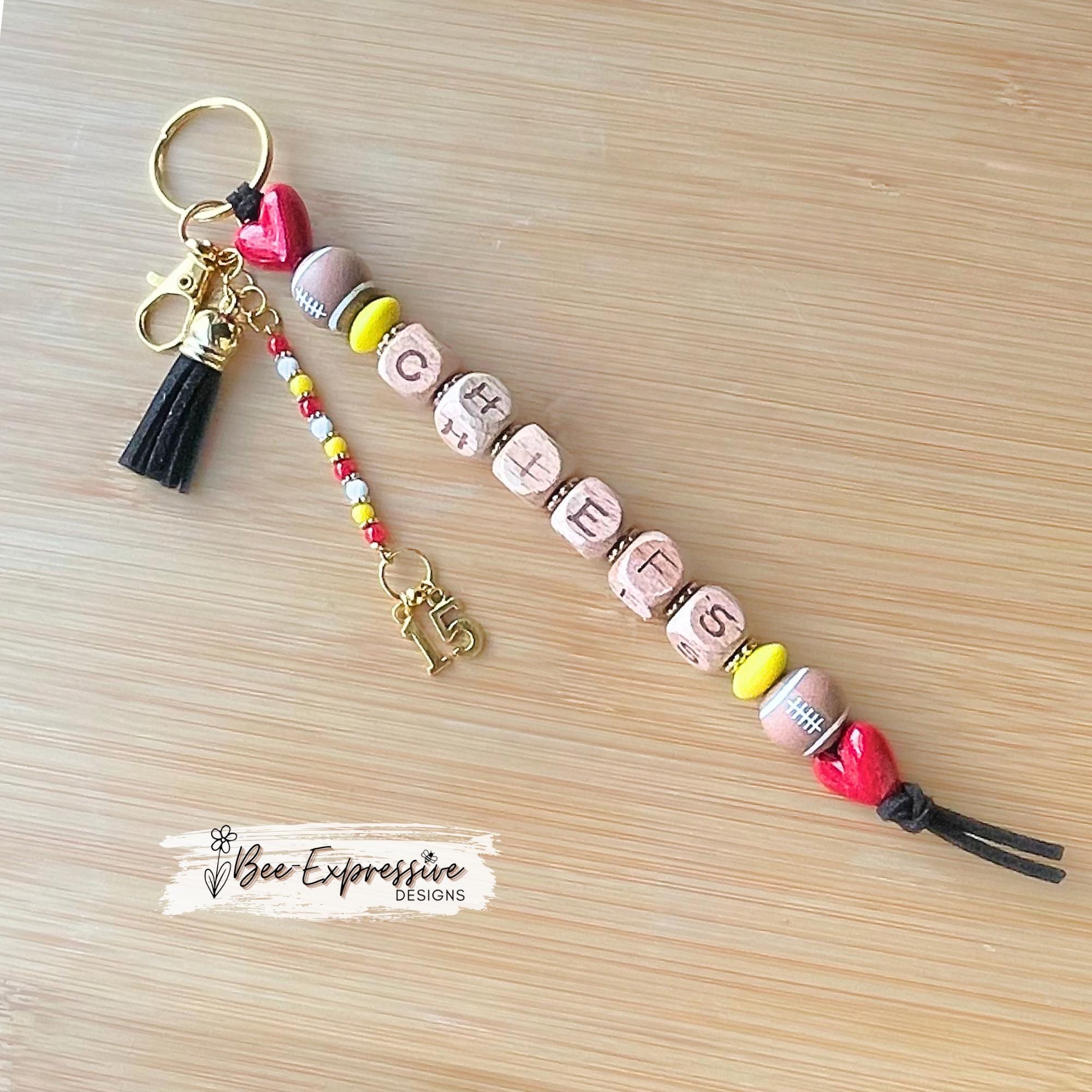 Handmade Chiefs Football Beaded Keychain: beaded tassel with custom jersey # charm, square wood beads.